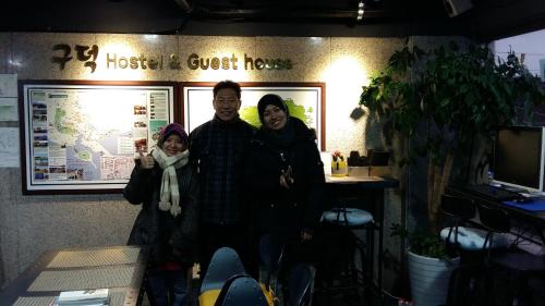 a group of people posing for a picture in a office at Gudeok Guesthouse in Seogwipo