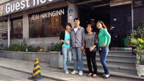 a group of people standing in front of a building at Gudeok Guesthouse in Seogwipo