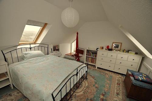 a bedroom with a bed and a dresser at No 1 Broughton Bed & Breakfast in Pierowall