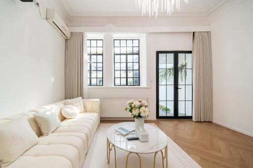 a living room with a white couch and a table at Tonight Homestay West Nanjing Road Shanghai in Shanghai