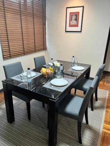 a black dining room table with chairs and a black table and chairsktop at Asoke Residence Sukhumvit by UHG in Bangkok