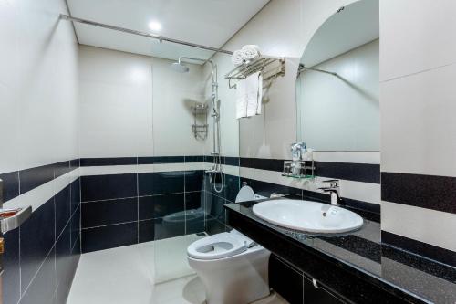 a bathroom with a sink and a toilet at Hummer Hotel & Apartment Da Nang Beach in Da Nang