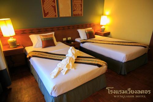 Ένα ή περισσότερα κρεβάτια σε δωμάτιο στο Wienglakor Hotel Lampang