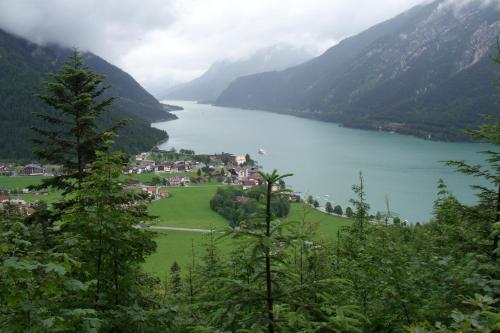 a lake in the middle of a valley with mountains at Landhaus Achental in Pertisau