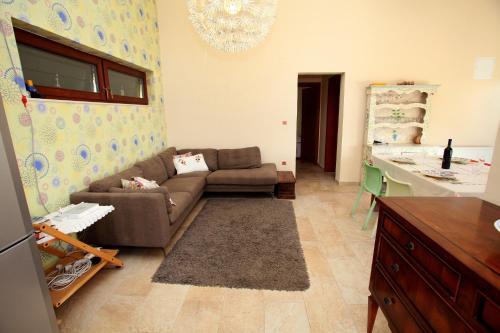 a living room with a couch and a kitchen at Villa Irena in Vinišće