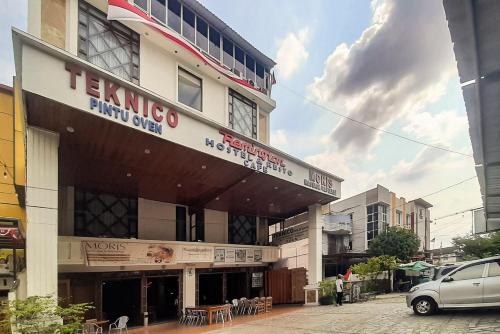 a building with a sign on the front of it at Urbanview Remington Hotel Palembang By RedDoorz in Palembang