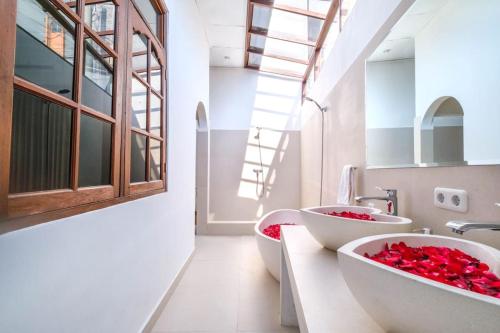 a bathroom with two sinks with red roses in them at Private 3BR Villa Bali Work & Relax Retreat near Canggu, Bathtub in Dalung