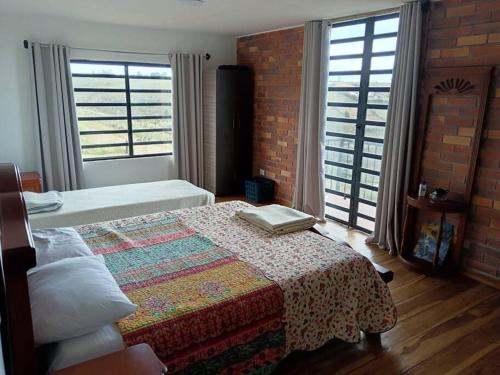 a bedroom with a bed with a blanket on it at Parcela Monte Alto Galería in Los Santos
