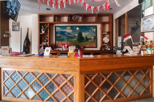 a store with a wooden counter with a display case at Urbanview Remington Hotel Palembang By RedDoorz in Palembang