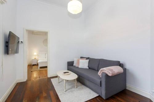 a living room with a couch and a table at The Coastal Nest - South Fremantle in South Fremantle