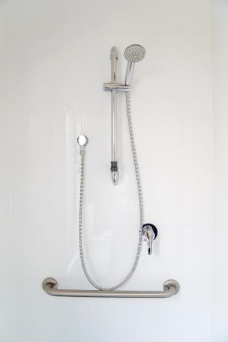a shower with a hose and a shower head at Villas on the Bay Kingscote in Kingscote