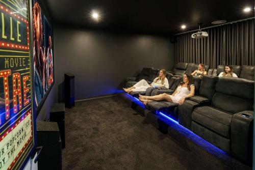 a group of women sitting on couches in a game room at Luxury Modern Country Retreat in Kin Kin