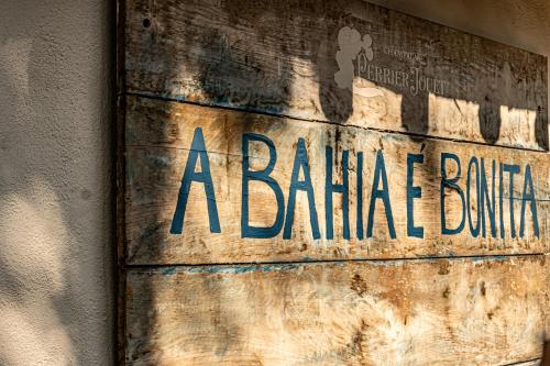 a palemate building sign on the side of a wall at Hotel Boutique Bahia Bonita in Trancoso