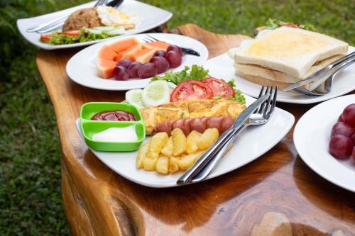 a table with plates of food on a table at JavaLO Villa Lombok in Sengkol