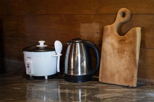 a coffee maker and a tea kettle on a counter at JavaLO Villa Lombok in Sengkol