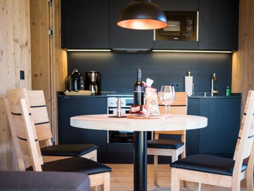a kitchen with a table with a glass of wine at Das Wiesegg in Fügenberg