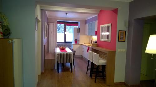 a kitchen with a small table and a dining room at Parkview Apartments in Sofia