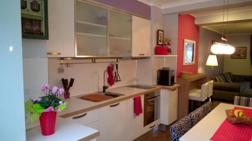 a kitchen with white cabinets and a counter top at Parkview Apartments in Sofia