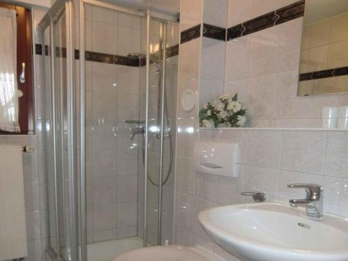 a bathroom with a shower and a sink at Landhaus Panoramablick in Schonach