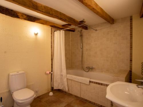 a bathroom with a toilet and a tub and a sink at Maison de charme avec jardin clos et Wifi au cœur du Périgord Noir - FR-1-616-401 in Saint-Pompont