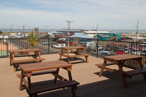 a group of picnic tables on a deck with a marina at Westport Inn in Westport