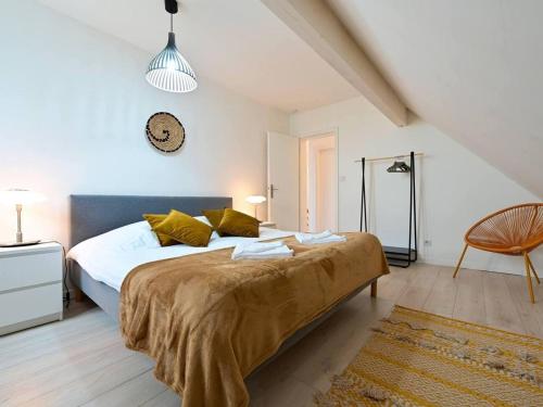 a bedroom with a large bed and a chair at Maison moderne avec jardin, confort et proximité Lille - FR-1-510-227 in Marcq-en-Baroeul