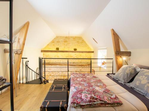 a bedroom with a bed in a attic at Chaleureuse escapade périgourdine avec terrasse et mezzanine - FR-1-616-419 in Auriac-du-Périgord