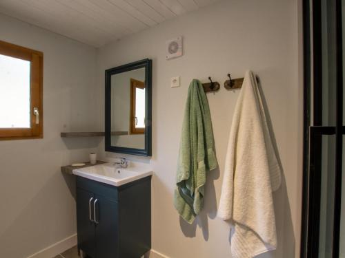 a bathroom with a sink and a mirror at Chalet bois intime avec Wifi, piscine partagée, à 1 km de St Pompont - FR-1-616-429 in Saint-Pompont