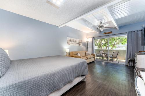a bedroom with a bed and a living room at Beautiful Kihei Hideaway Studio Across the Beach LSV02 in Kihei