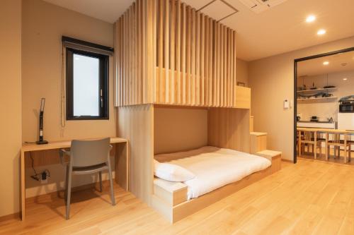 Ένα ή περισσότερα κρεβάτια σε δωμάτιο στο TEN APARTMENT HOTEL Hakata Reisen