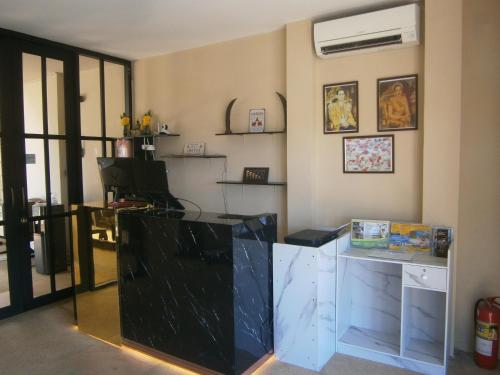 a room with a desk with a glass counter top at Infinity Boutique Hotel Kata Beach in Kata Beach