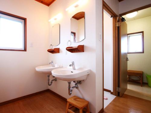 a bathroom with two sinks and two mirrors at Beach and Mountain in Ishigaki Island