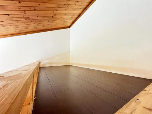 an empty room with a wooden table and a ceiling at Beach and Mountain in Ishigaki Island
