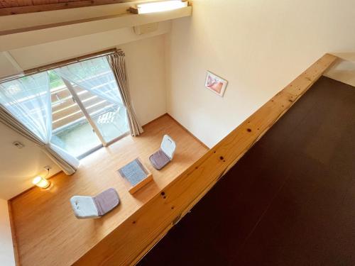 an overhead view of a room with a staircase with books at Beach and Mountain in Ishigaki Island