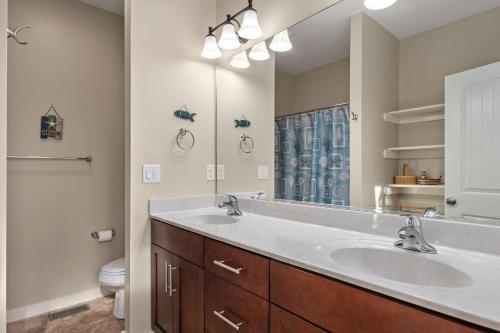 un bagno con due lavandini e un grande specchio di CB34 Salty Breeze a Corolla