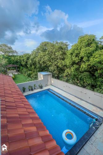 a swimming pool on top of a house at Parambi by Soumils Stays in Longhar
