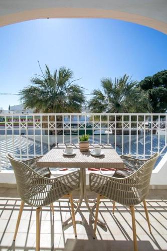 a table and chairs on a balcony with a view of the ocean at Lardos Sun View Apartments in Lardos