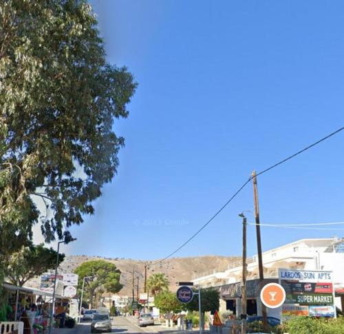 a street in a town with buildings and a blue sky at Lardos Sun View Apartments in Lardos