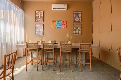 a dining room with a table and chairs at The Wood Terrace in Ban Chin Tham Mai