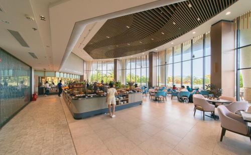 a woman standing in a food court in a restaurant at Hese Pool Villas & Resort Cam Ranh in Cam Ranh