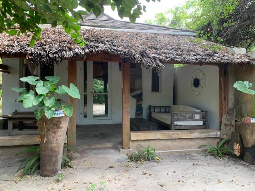 a small house with a thatched roof at The Slow Leopard Kilwa in Kilwa Masoko