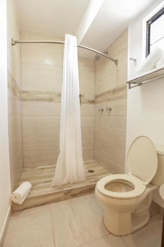 a bathroom with a shower with a toilet at Royal Suite Cananea in Cananea