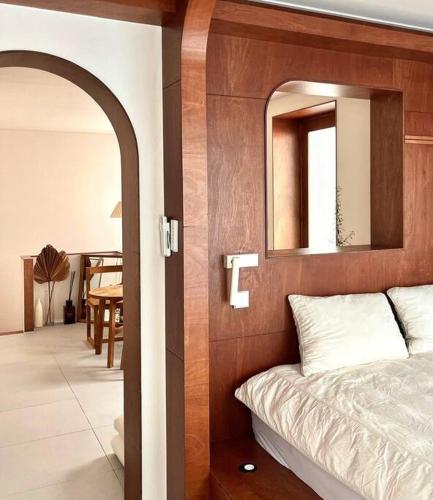 a bedroom with a bed with a mirror above it at 영도 여는 in Busan