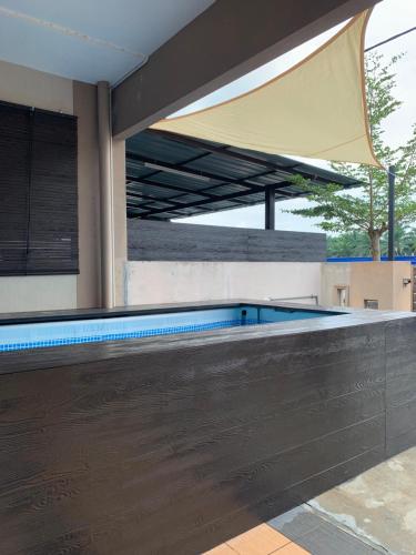 an empty swimming pool with awning over it at Impiana Inn Seri Manjung in Seri Manjung