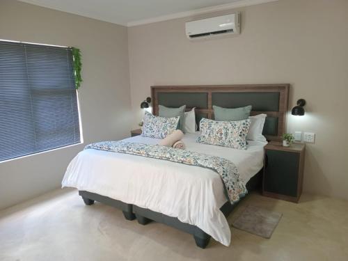 Ένα ή περισσότερα κρεβάτια σε δωμάτιο στο Taíta Lodge