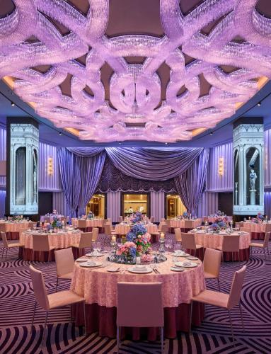 a ballroom with tables and chairs and a purple ceiling at Grand Hyatt Mumbai Hotel and Residences in Mumbai