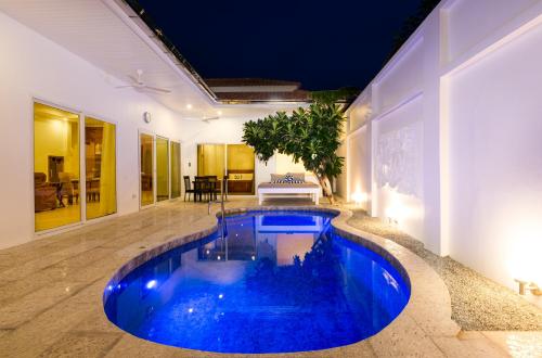 a large blue pool in the middle of a house at Villa Franken Luxury Pool Villa in Pattaya South
