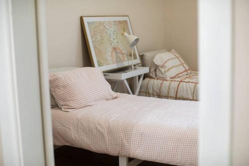 a small bedroom with a bed and a mirror at Central Delight in Dubbo