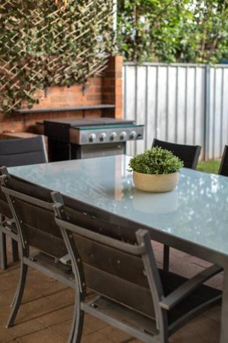 a table with a potted plant sitting on a patio at Central Delight in Dubbo