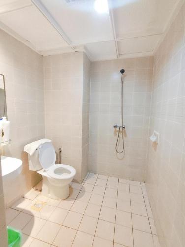 a white bathroom with a toilet and a sink at Regency Tanjung Tuan - Idealhub in Port Dickson